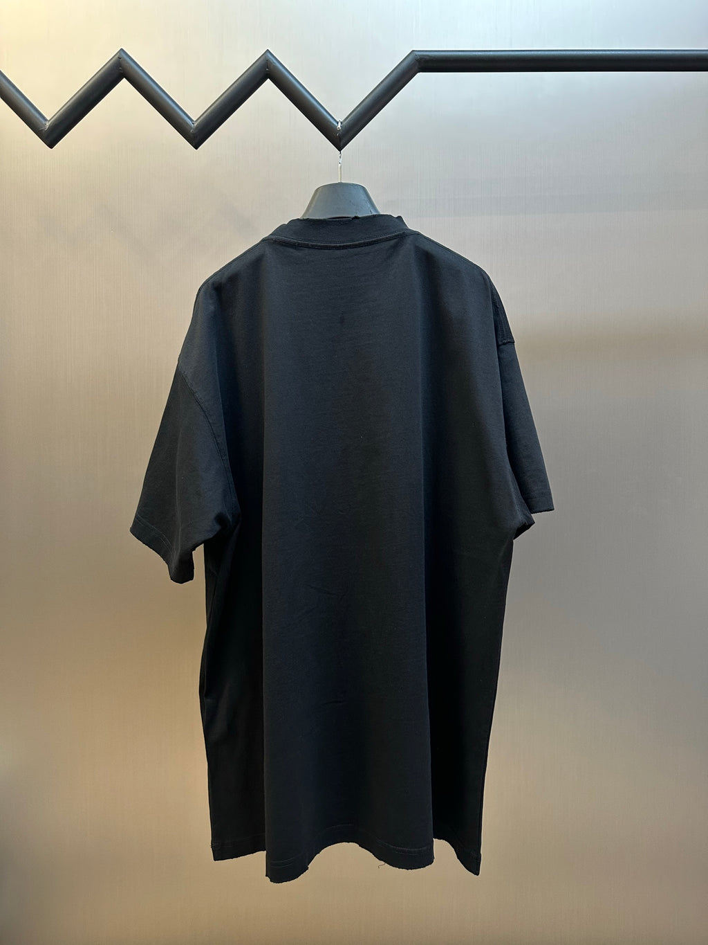 Black T-shirt back view with large neon graphic and short sleeves