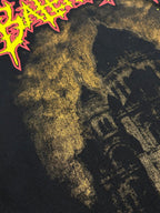 Dark T-shirt close-up of gold-toned building graphic and neon edge