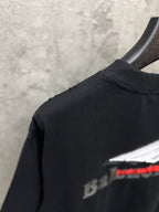 Black T-shirt with partial Balenciaga logo visible near shoulder