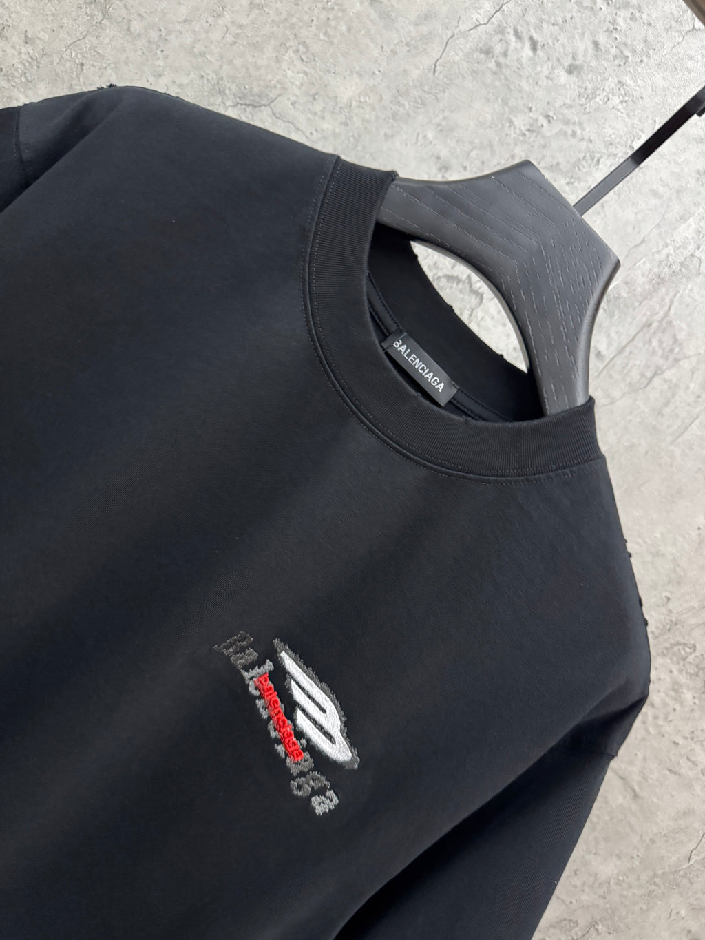 Black crewneck T-shirt with small chest logo detail and neckline close-up