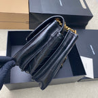 YSL leather shoulder bag, dark blue, side view with gold chain strap and hardware