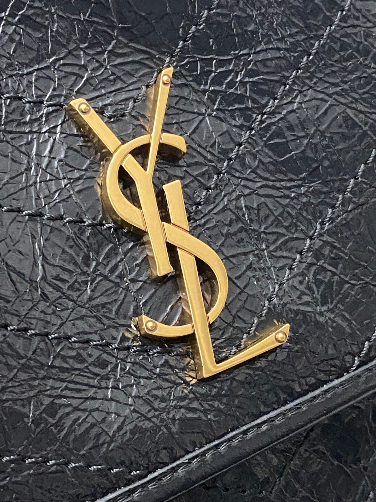 YSL logo plate on textured dark blue leather flap, gold hardware detail