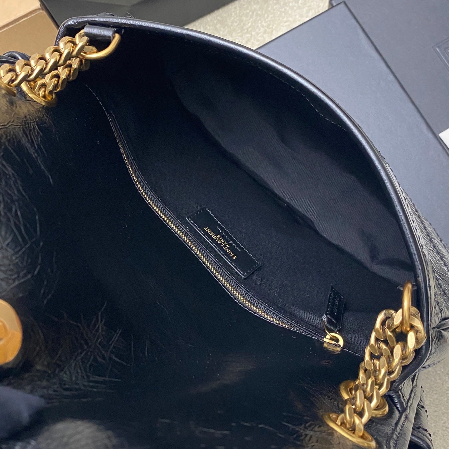 YSL leather shoulder bag interior pocket detail, dark blue lining with gold clasp