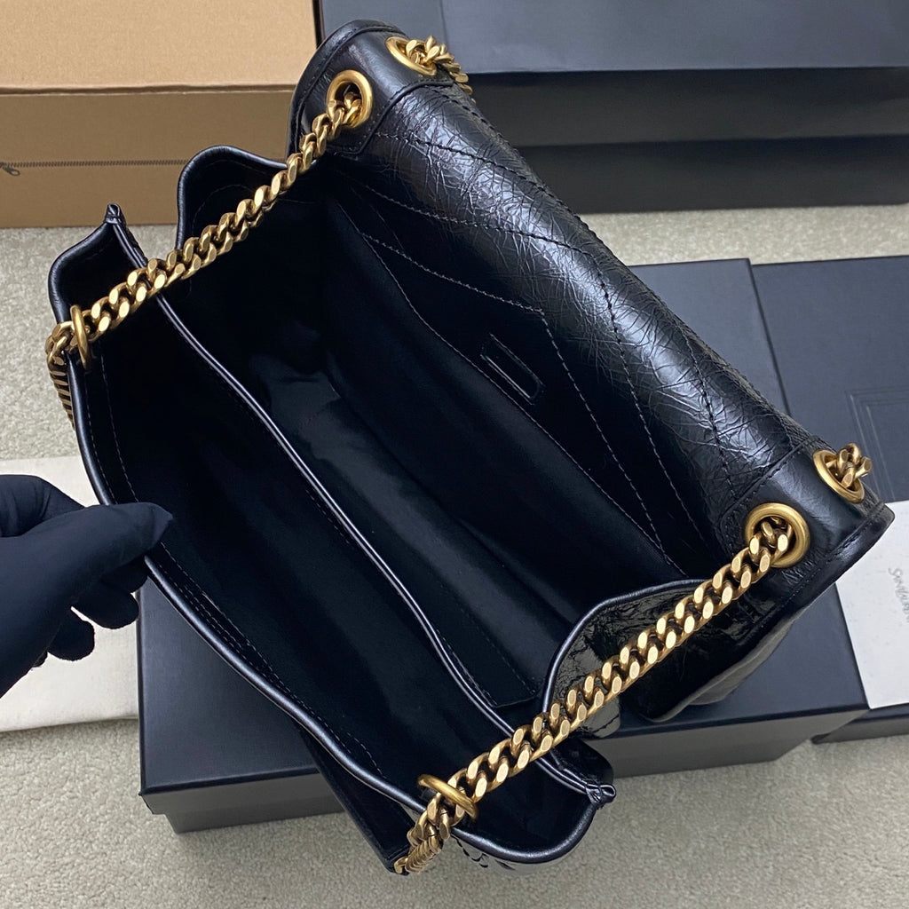 YSL leather shoulder bag interior view, dark blue lining with gold chain trim