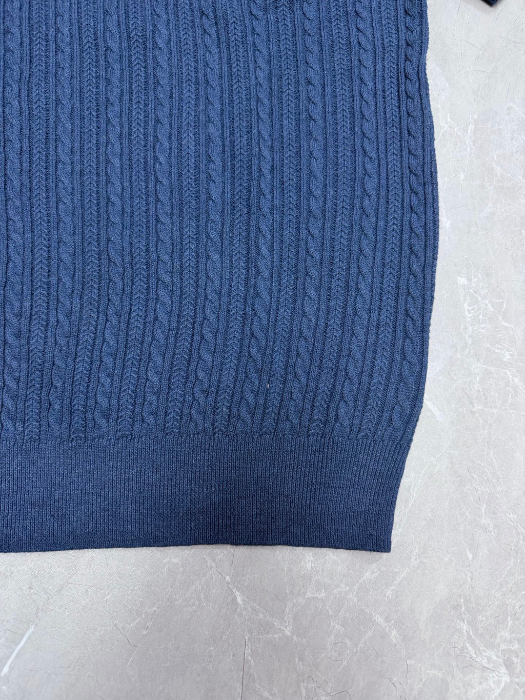 Ralph Lauren blue knit polo hem with textured cable pattern