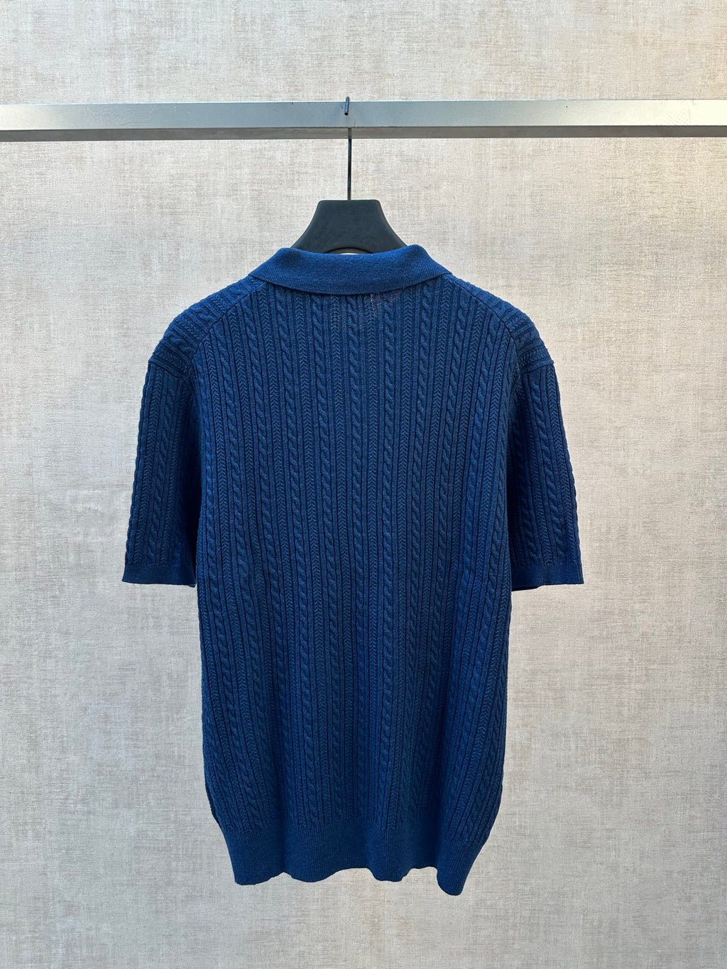 Blue cable-knit polo shirt back view with ribbed collar and short sleeves