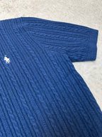 Blue cable-knit polo shirt sleeve cuff and knit texture detail