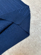 Blue knit polo shirt shoulder seam and ribbed collar detail