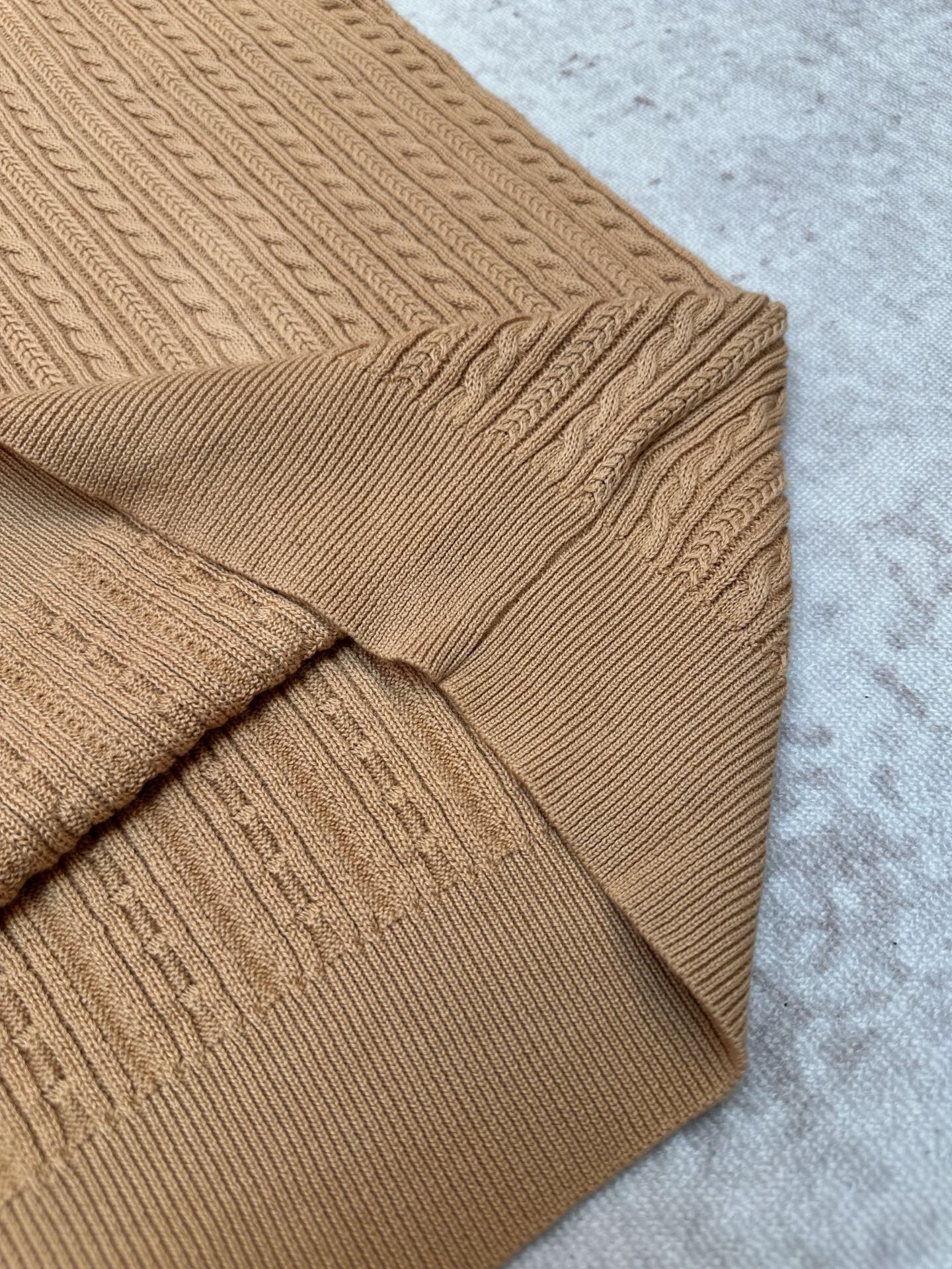 Tan cable-knit polo with sleeve and shoulder seam detail