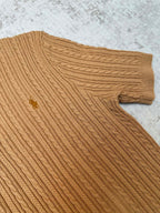 Tan cable-knit polo shoulder and sleeve cuff with textured knit pattern