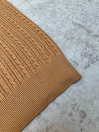 Tan cable-knit polo sleeve and side hem detail
