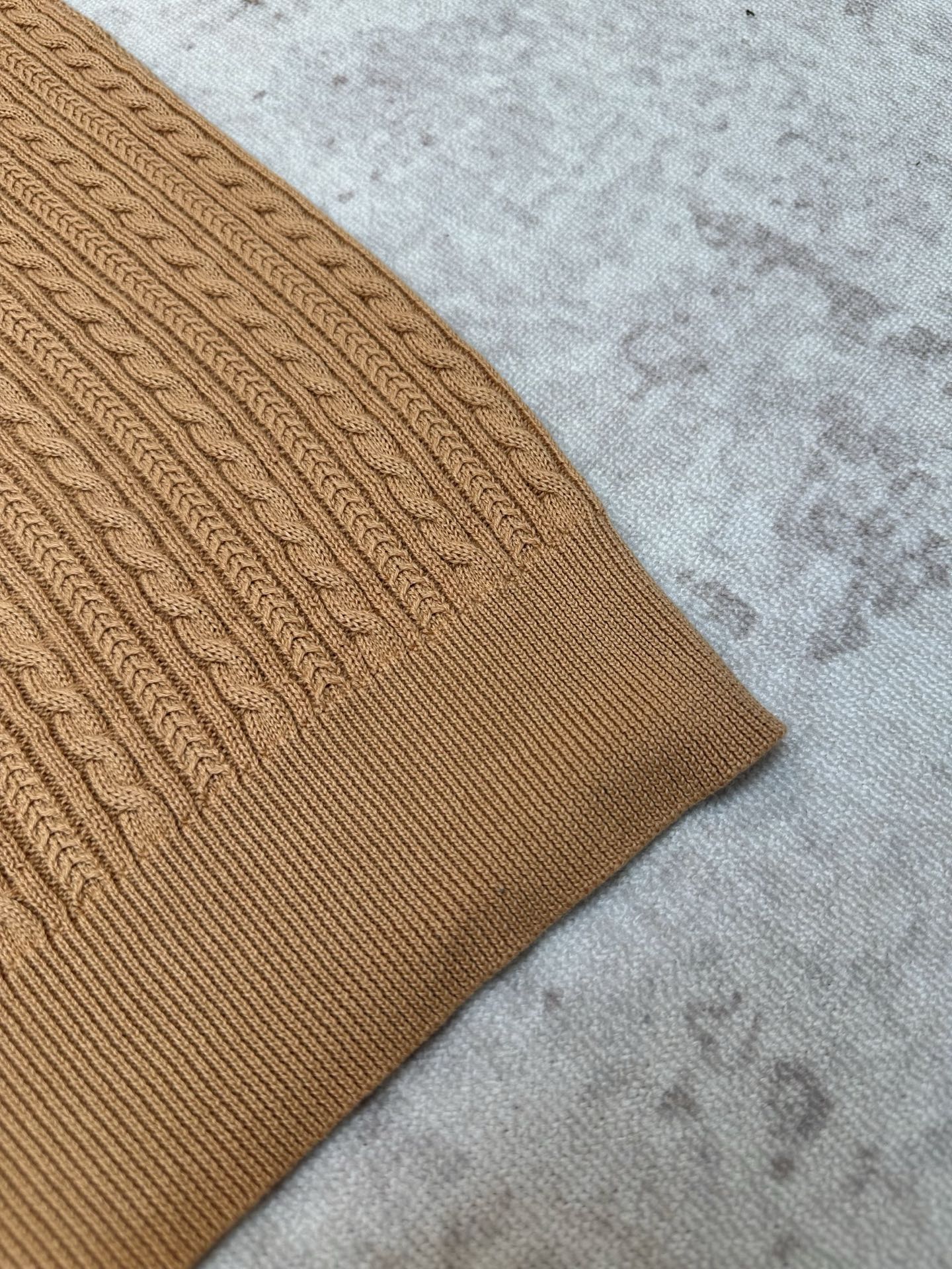 Tan cable-knit polo sleeve and side hem detail