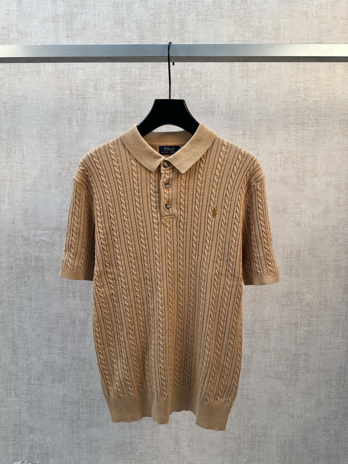 Tan cable-knit polo shirt with short sleeves and 3-button placket