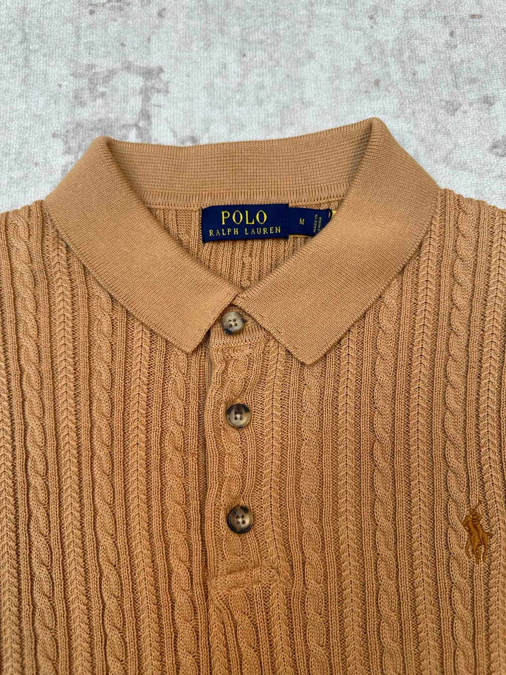 Tan cable-knit polo collar and button placket with Polo Ralph Lauren label