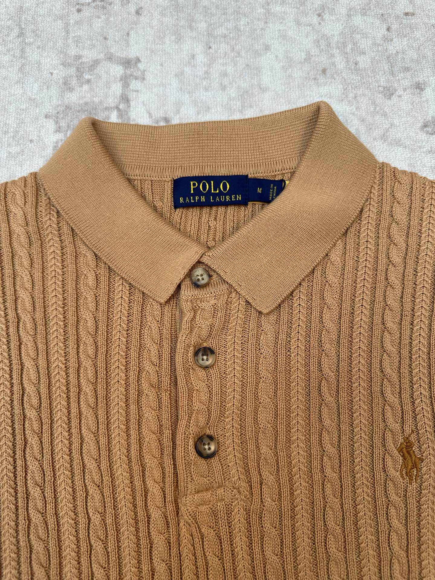 Tan cable-knit polo collar and button placket with Polo Ralph Lauren label