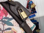 Louis Vuitton bag strap closeup with gold LV lock hardware on black leather trim