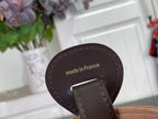 Louis Vuitton bag closeup of 'made in France' leather patch on dark strap