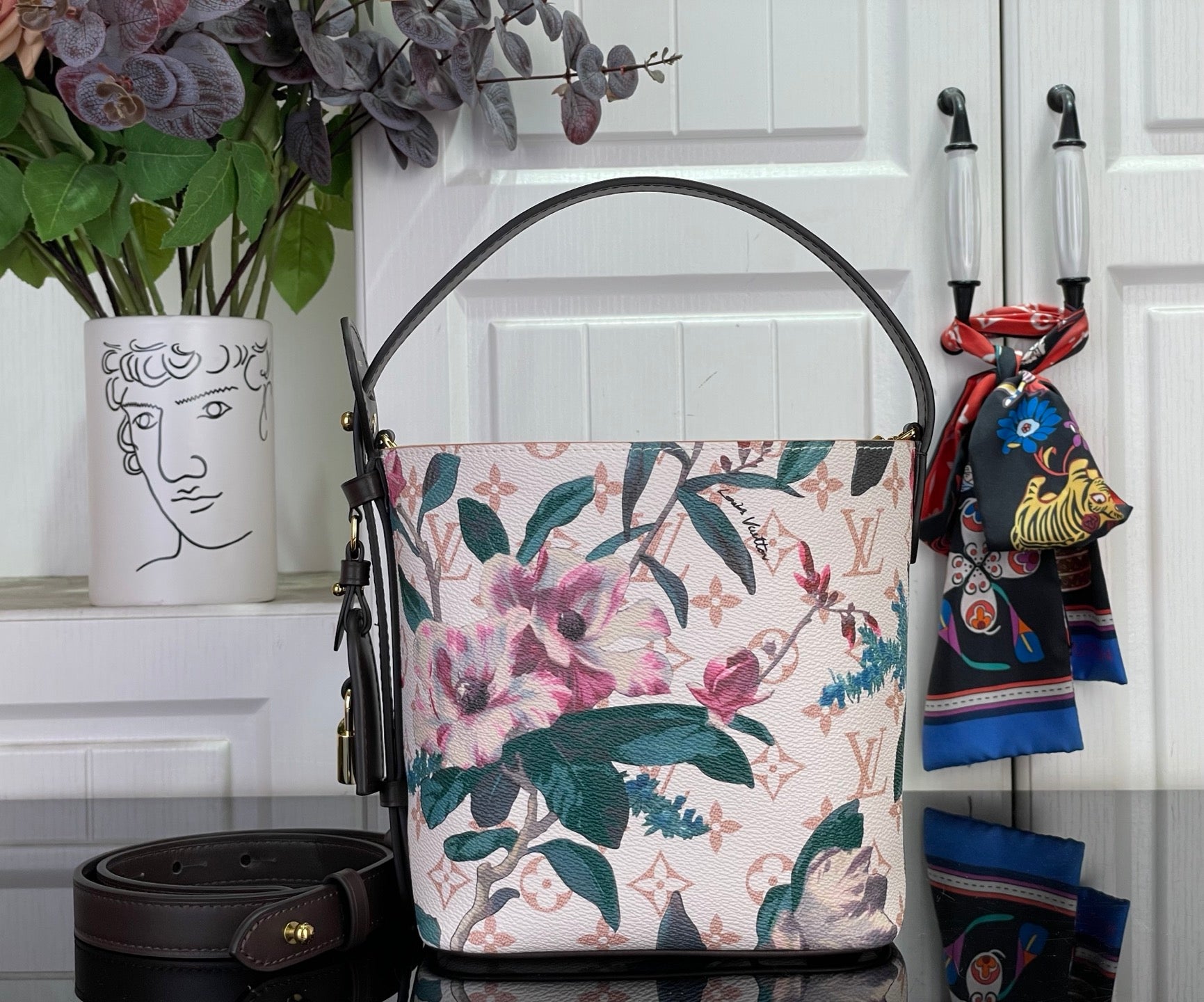 Louis Vuitton shoulder bag with multicolor floral canvas, black leather straps and front pocket