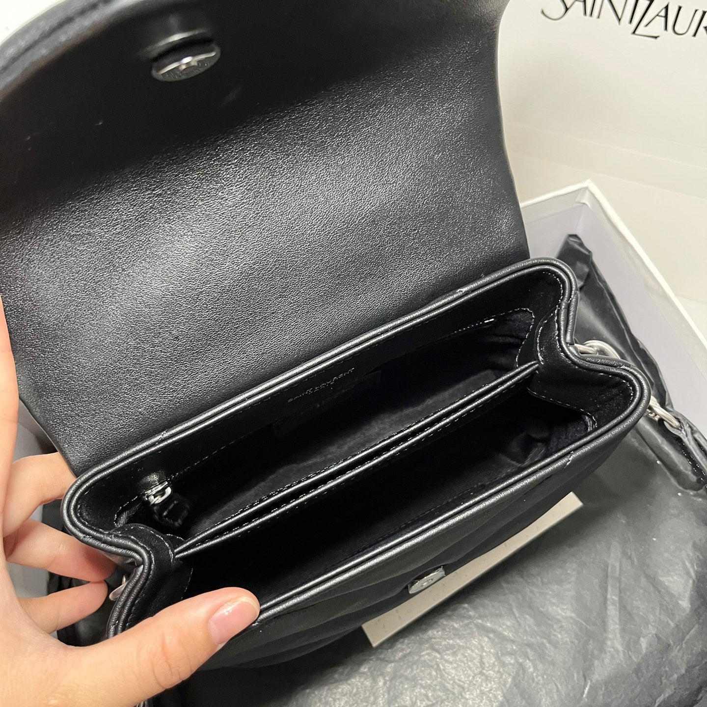 YSL bag open interior with stitched lining and dark leather inner compartment