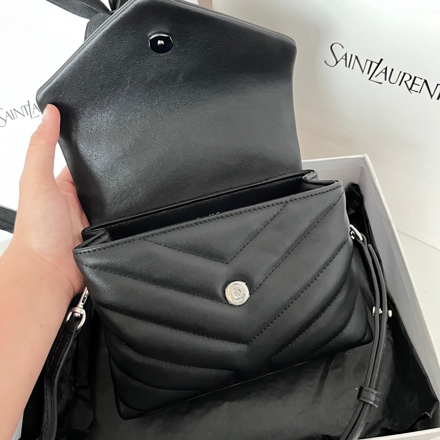 YSL bag top with dark snap button and quilted front detail
