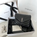 YSL bag with quilted dark leather, chevron stitching, and YSL logo on flap