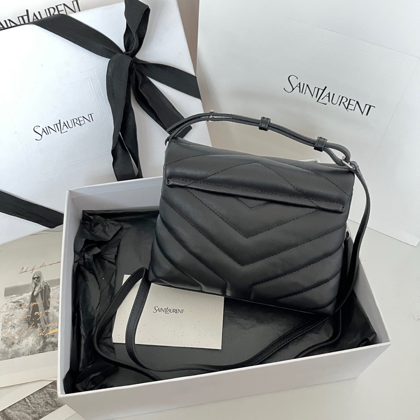YSL bag in dark leather with top handle and quilted chevron pattern
