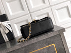 Chanel quilted mini bag in black with gold-toned chain strap and top handle