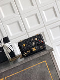Chanel quilted mini bag in black with gold chain strap and decorative charms