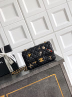 Chanel quilted mini bag in black with gold chain strap and decorative charms