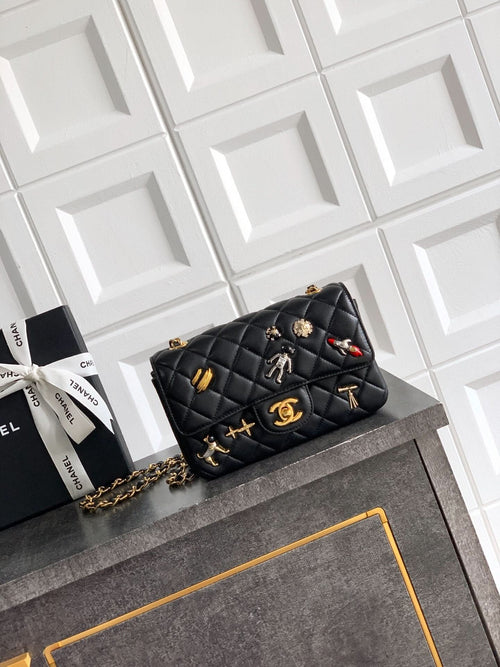 Chanel quilted mini bag in black with gold chain strap and decorative charms