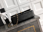 Black Chanel quilted shoulder bag with gold chain strap and flap top