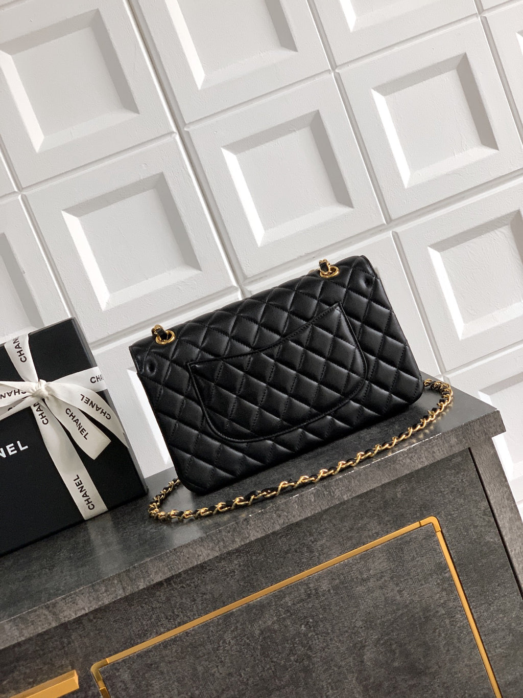 Black Chanel quilted crossbody bag with gold chain strap and stitched diamond pattern
