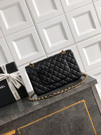 Black Chanel quilted crossbody bag with gold chain strap and stitched diamond pattern