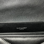 Embossed Saint Laurent Paris label on dark leather trim