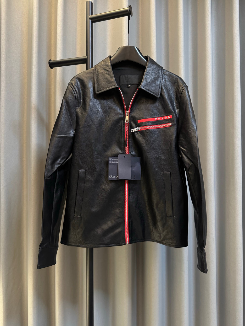 Prada black leather jacket with red zip and logo stripe at chest