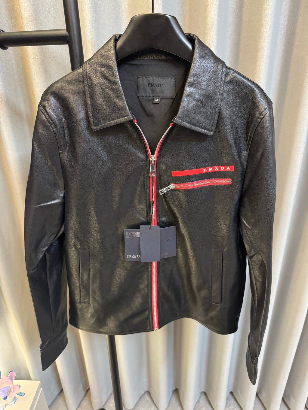 Prada black leather jacket with red zipper trim and chest logo stripe