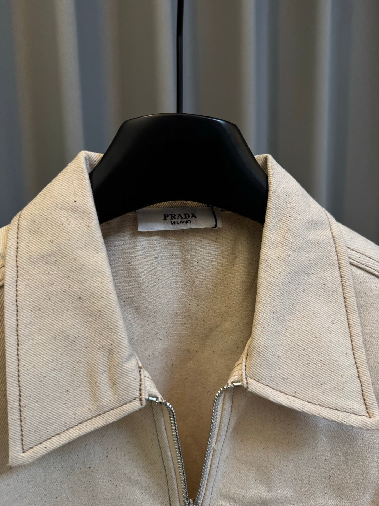 Prada beige canvas jacket with stand collar and fabric label at neckline