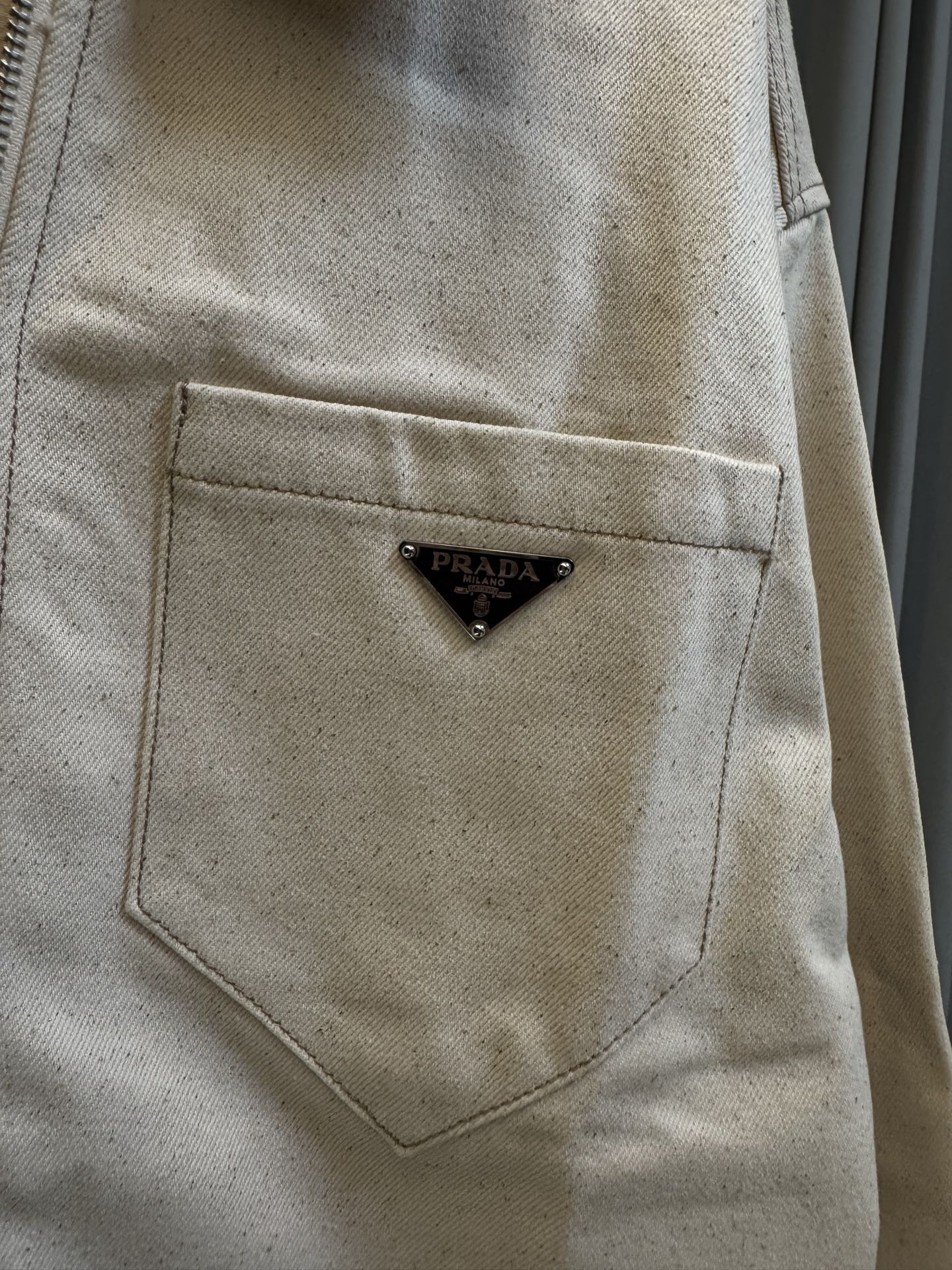 Prada beige canvas chest pocket with triangular logo patch