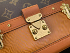 Tan leather strap detail with gold-tone front clasp and Louis Vuitton engraved plate