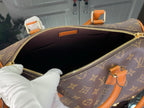 Monogram handbag interior view with dark lining and gold-tone zipper at top opening