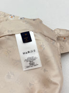 Beige short-sleeve shirt with white care label on inner yoke
