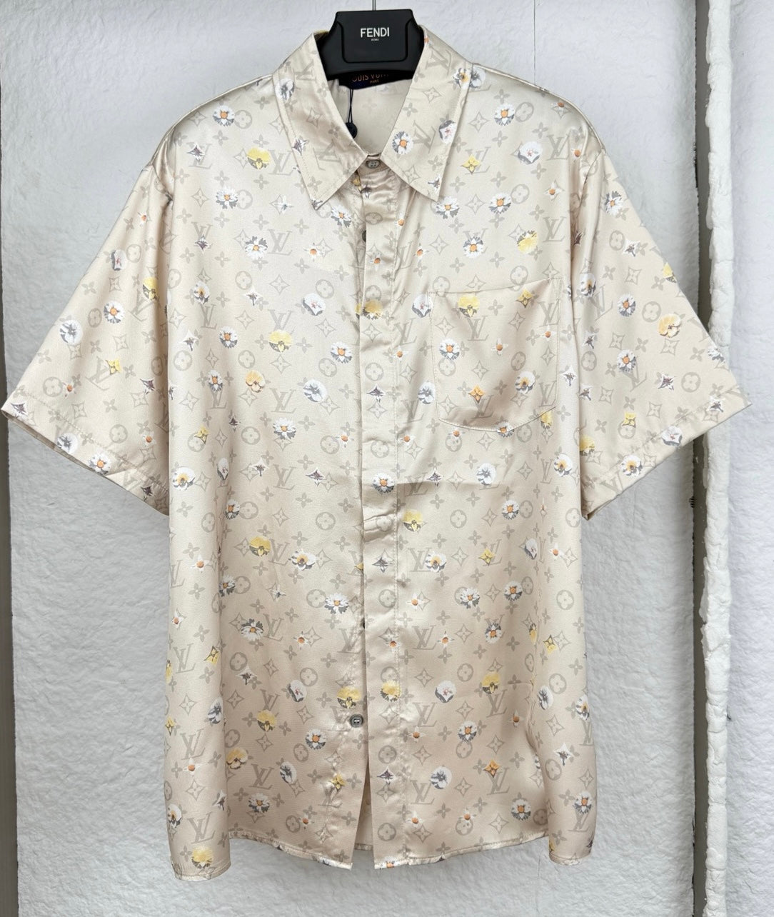 Beige short-sleeve button-up shirt with allover monogram and small floral icons