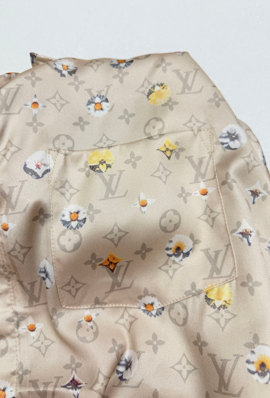 Beige short-sleeve shirt fabric with colorful floral monogram pattern