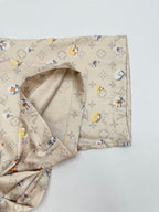 Beige short-sleeve shirt sleeve with interior facing and monogram floral print