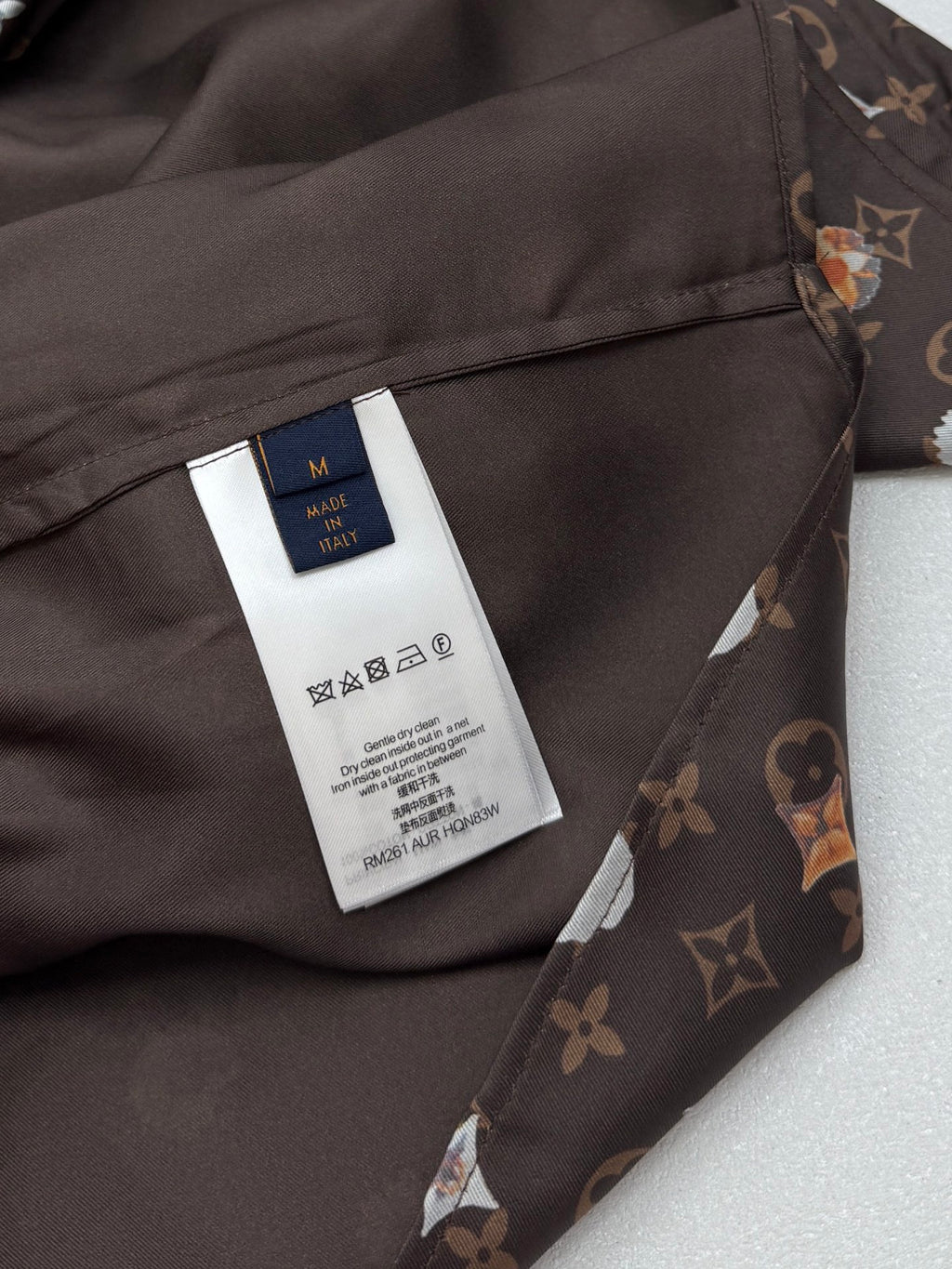 Louis Vuitton shirt care label on inner placket, dark monogram floral fabric