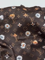 Louis Vuitton short-sleeve shirt, dark monogram print with colorful floral motifs (close-up)