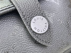 Louis Vuitton leather patch tab with embossed “Louis Vuitton Paris” on black bag