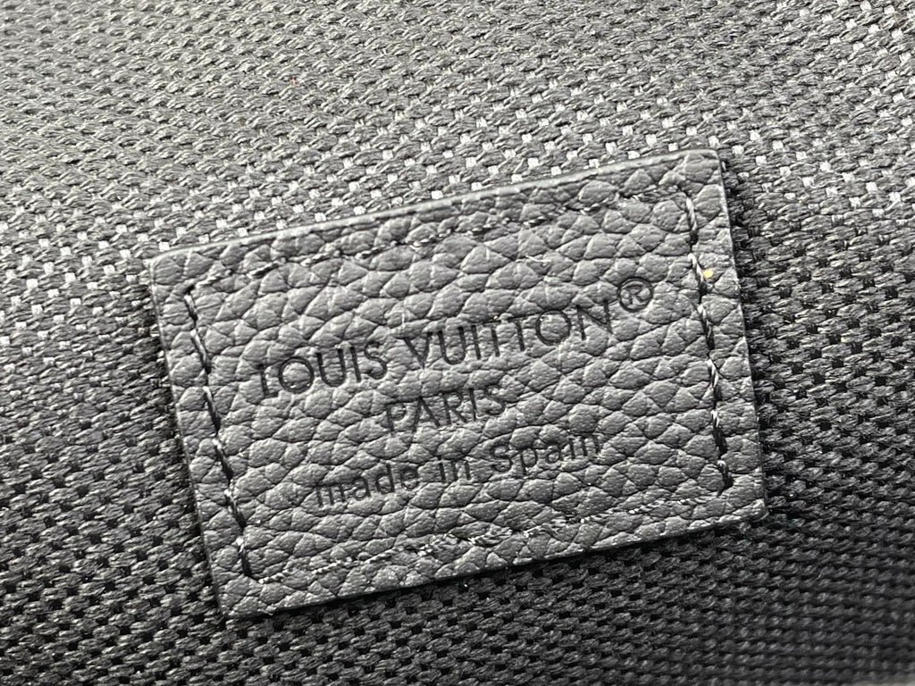 Louis Vuitton embossed card holder panel on black textured crossbody bag