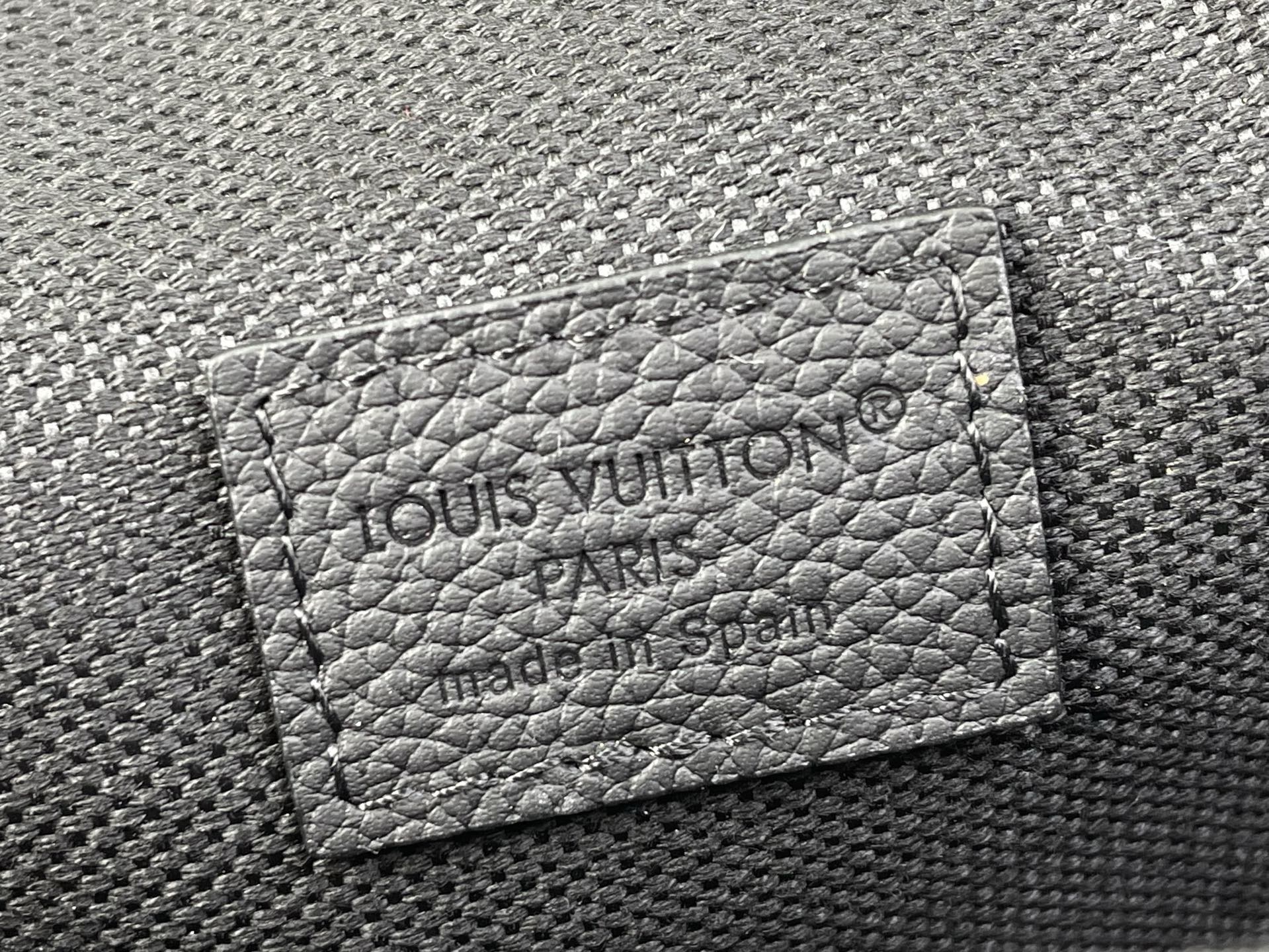 Louis Vuitton embossed card holder panel on black textured crossbody bag