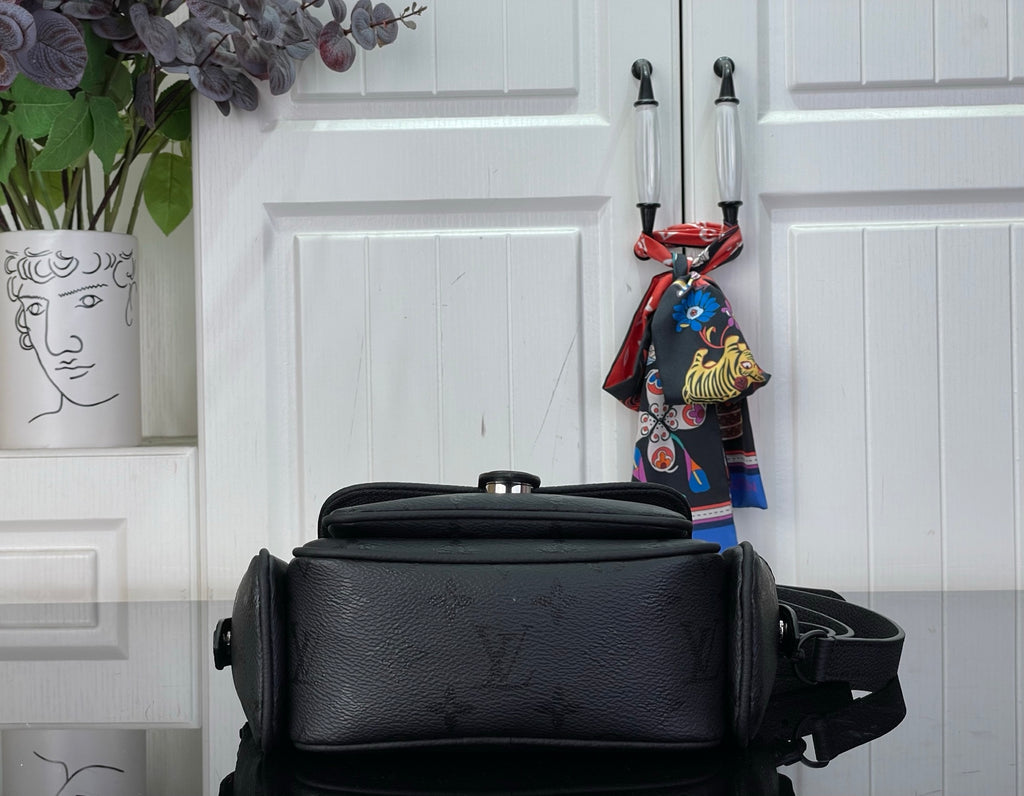 Louis Vuitton black crossbody bag with top handle and flap closure